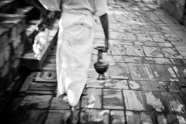 In similar white robes and performing similar rituals as the kin of the deceased, the only difference I could spot was that those who did it professionally looked more bored than somber.