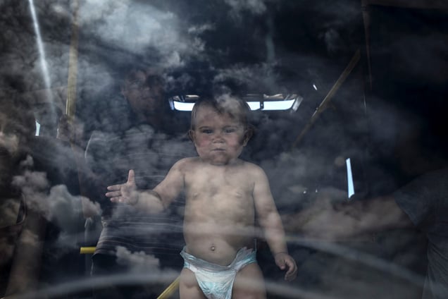 Refugee family and their child in the bus at the Izvarino border crossing point