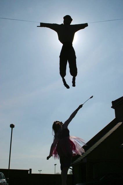 Between the houses of a Jewish street in Stamford Hill the figure of Haman in suspended in the sky during the festival of Purim. A young girl dressed as a fairy for Purim try’s to hit it with her wand. Purim is one of the most entertaining Jewish holidays.  It commemorates the time when the Jewish people living in Persia were saved from extermination from a massacre by Haman.