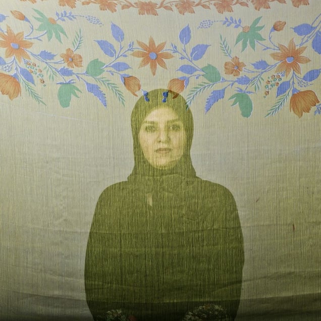 Mayha, an Iranian woman is photographed through the fabric of her hijab (the Islamic headscarf worn by women in the presence adult men who are not members of her immediate family). Since the Islamic revolution in 1979, Iranian women are not allowed to be seen in public without proper Islamic head dress in Iran. Not wearing a proper hijab is illegal and can result in arrest by a special police unit