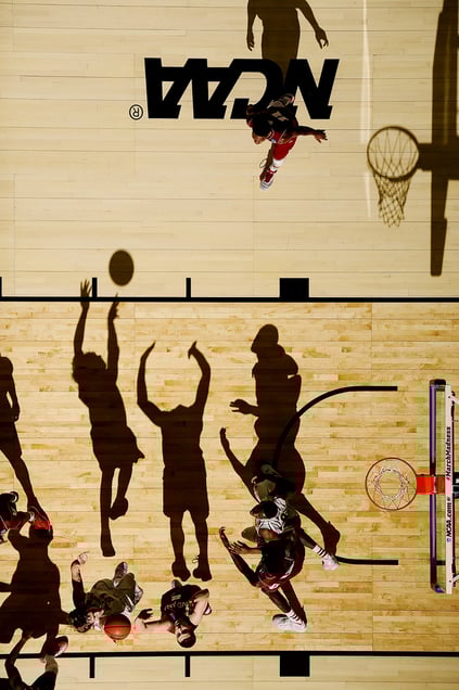 During the National Collegiate Athletic Association (NCAA) 2015 Mens Basketball Tournament game with Wichita State vs. Indiana, Ron Baker shoots over Nick Zeisloft whilst Hanner Mosquera-Perea and Rashard Kelly battle for position at the CenturyLink Center in Omaha, Nebraska, USA, on 20 March 2015.
