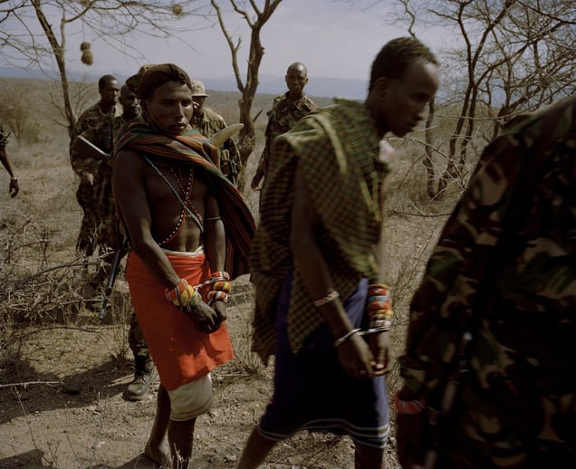 Oldonyiro, northern kenya, poachers are led from the bush by conservancy rangers-from the series 'with butterflies and warriors'-David Chancellor