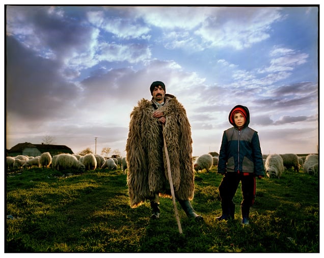 Old and New Times in Periam, Romania. Traditional sheep farmers are being pushed out as the younger generation prefers modern clothing made from synthetic and cotton materials.