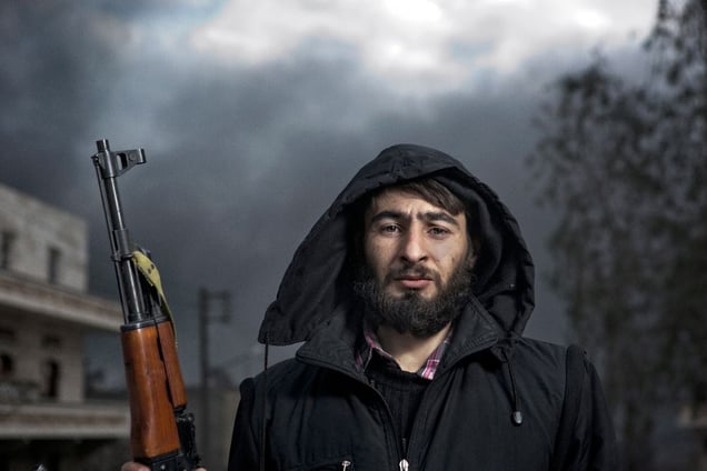 A Free Syrian Army (FSA) member stands for a portrait near the site of a government artillery strike in the Sakhour district of Aleppo on February 7, 2013.  © Nish Nalbandian