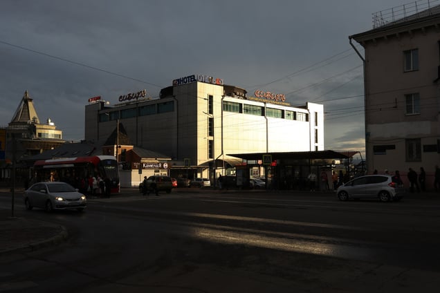 People disembark from a bus on a cloudy day in downtown Ulan-Ude, Republic of Buryatia on May 16, 2024.