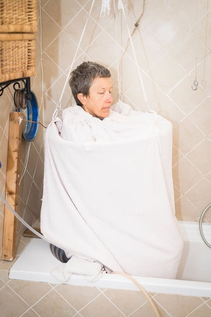 Luisa, 50 years old, pictured in her bathroom where she built a self-made sauna to clean herself from toxins.