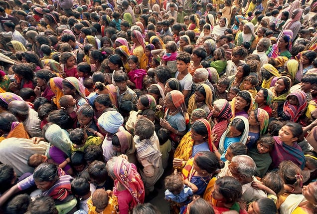 Bodh Gaya, India: Beggars hurry to listen to the teaching of his holiness the Dalai Lama, where they will receive some food and money. © Matjaz Krivic
