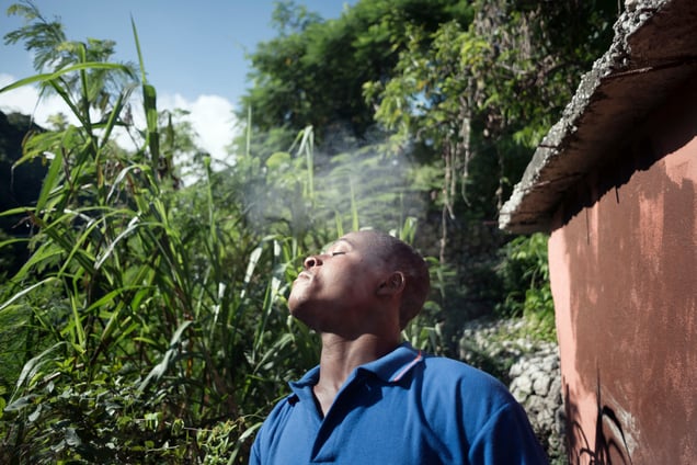 Makendy photographed while smoking outside his house .