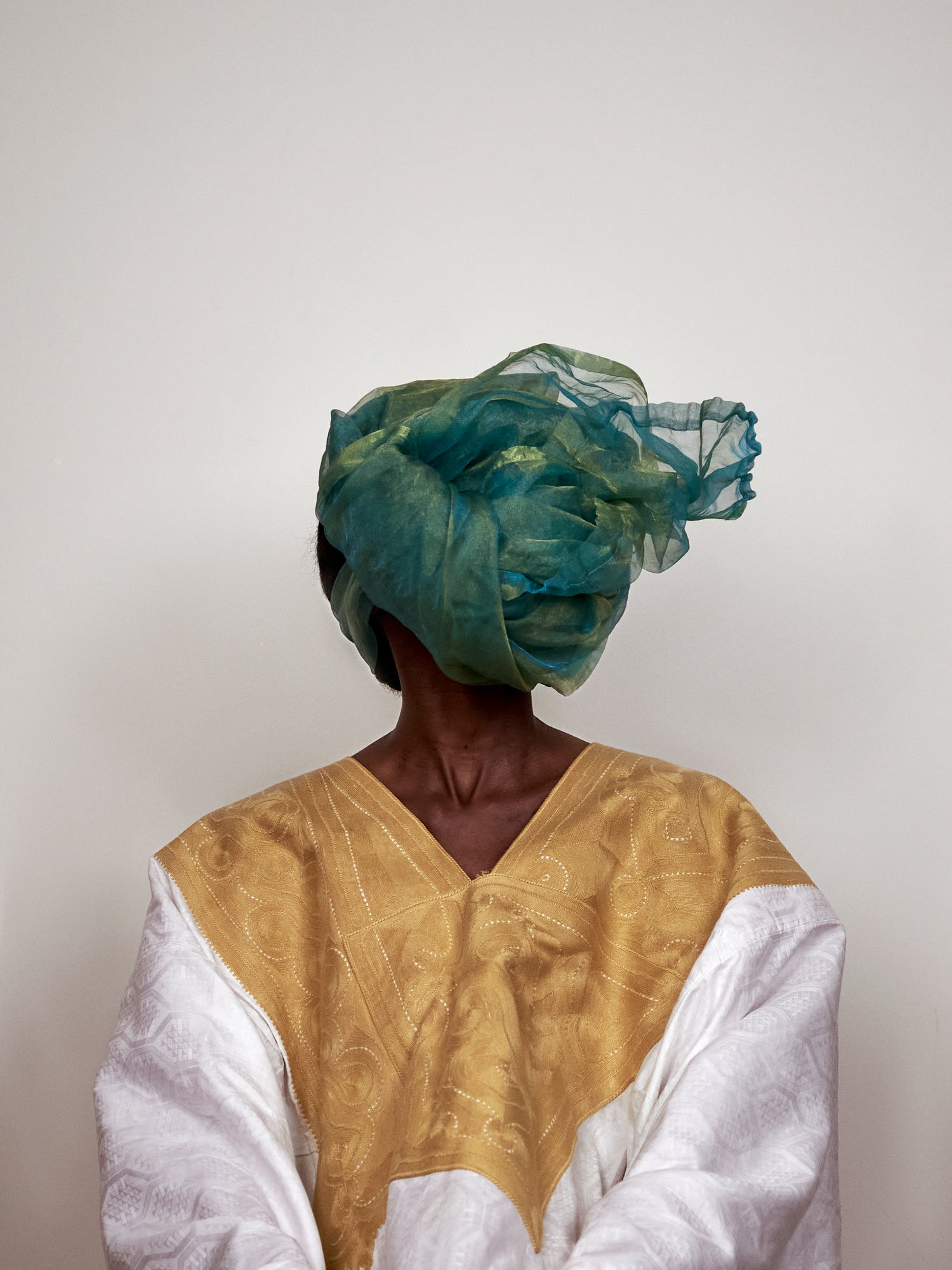 Souleymane bachir diaw, worn white grand-bubu with golden embroidery and green headscarf, grey area, 2021, series sutura, 2021–ongoing. courtesy of the artist.