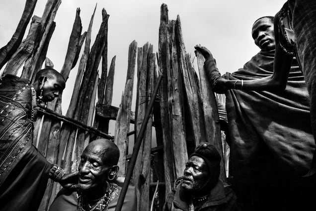 The father of the girls taking part of a ritual, where he and his four wives will be marked with okra. © Meeri Koutaniemi