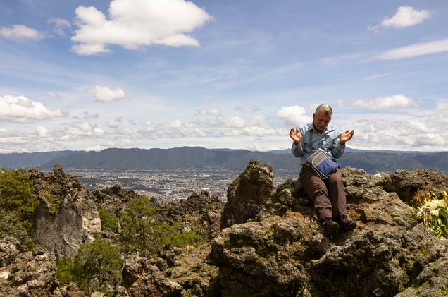 A man offering a prayer on the Almolonga volcano, also called Cerro Quemado, in Guatemala. The ancient Maya believed that volcanoes were holy places where the Gods and spirits resided. Cerro Quemado is considered one of the best places to get close to the Gods. Thats why people come from all over the region to pray and perform ceremonies, bringing flowers and sometimes food and alcohol to leave as offerings to God and the ancestors. Some people also believe that Juan Noj, a supernatural Maya being lives in the volcano.