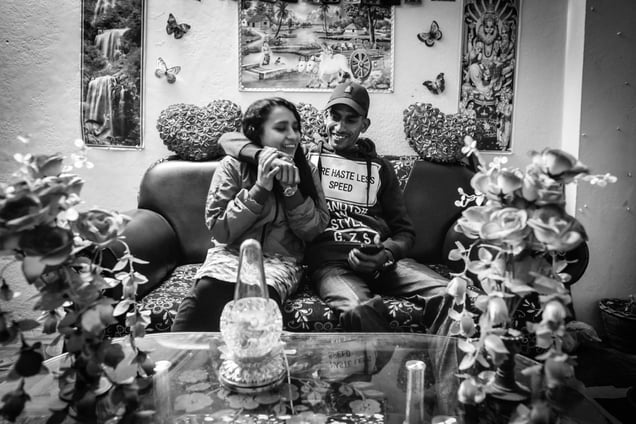 With his wife at his rented room near the temple premises. His wife understands his situation and tries to make most of the time he is at home, which is scarce.