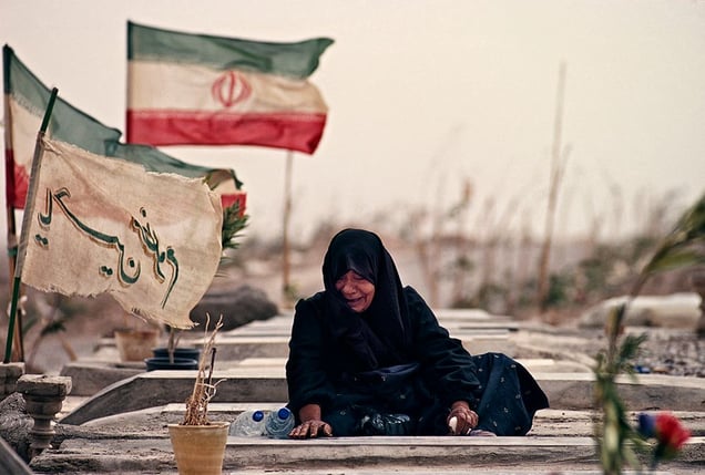 Bam, Iran: The woman mourns on the grave of her family that died in the cataclysmic 2003 earthquake. The earthquake flattened most of the town, including the legendary citadel. © Matjaz Krivic