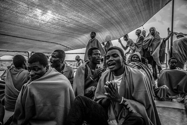 Migrants singing after being rescued