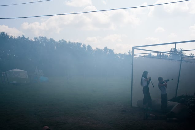 A fake grenade is launched, setting smoke in the atmosphere as students practice a drill with air-soft guns at  the Historical-War Camp, in Borodino, Russia. 29 July 2016. 350 adolescents are in attendance, ranging in ages from 11 to 16, and lasts throughout the summer. Students learn a variety of skills from tactical training in handguns, loading and unloading automatic guns, physical endurance,
