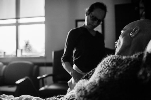 Laurel Borowick has a tender moment alone with her husband Howard, minutes after he passed away. They were married thirty-four years and shared their battles with cancer together side by side, until his death. Greenwich, Connecticut. December 2013 © Nancy Borowick
