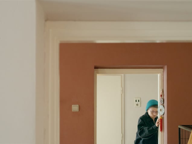 A residential interior in Novi Sad, Serbia. The final image returns to private space, where newer finishes, older doors, and a Chinese hanging charm coexist within the same domestic threshold.