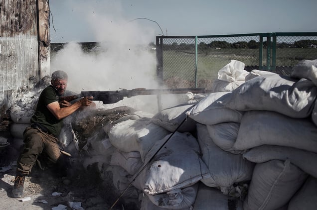 A rebel fires near the Krasnyi Partizan checkpoint