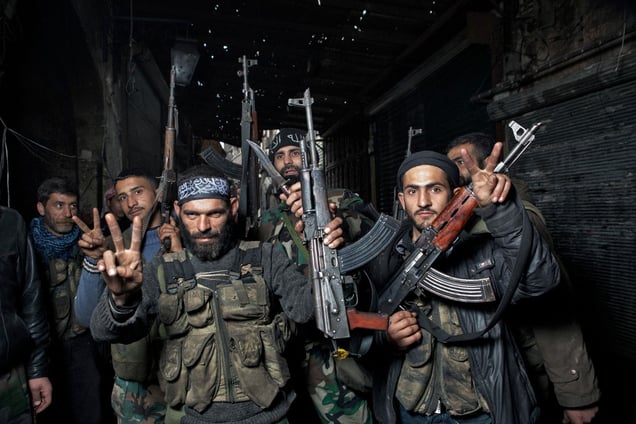 A group of Syrian rebel fighters pose for a portrait near the Old City Front Line in Aleppo on February 9, 2013. © Nish Nalbandian