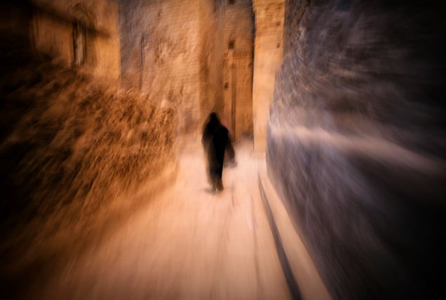 Thulla, Yemen: A woman is walking through the narrow streets of historical town. © Matjaz Krivic