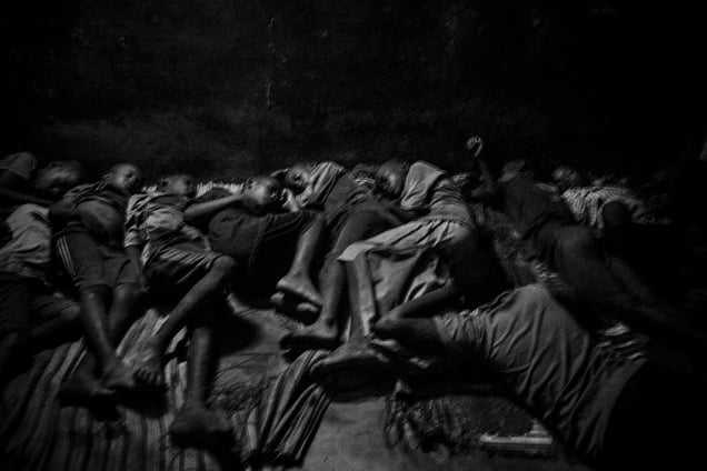 Talibes sleep next to each other inside a daara on the concrete floor without any protection. Saint Louis, Senegal, 21 May 2015.