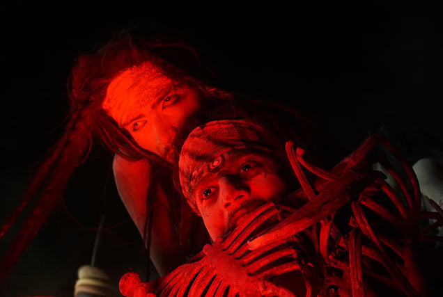 A devotee walks through ash, carrying Shiva within.