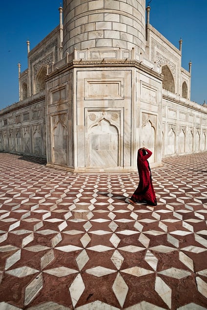 Agra, India: A woman passing the crown of palaces. The white marble mausoleum of Taj Mahal. © Matjaz Krivic