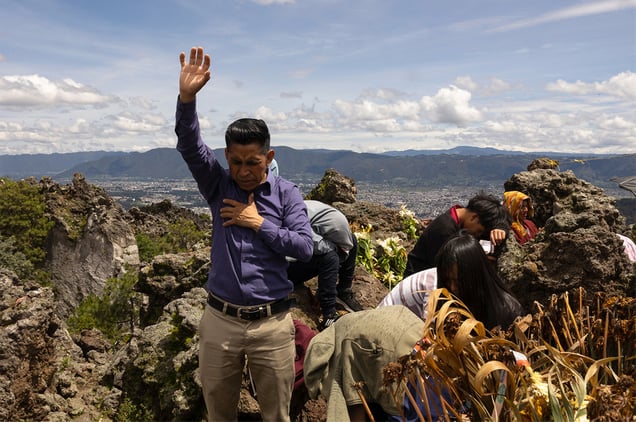 Locals and people across the region offering a prayer on the Almolonga volcano, also called Cerro Quemado, in Guatemala. The ancient Maya believed that volcanoes were holy places where the Gods and spirits resided. Cerro Quemado is considered one of the best places to get close to the Gods. Thats why people come from all over the region to pray and perform ceremonies, bringing flowers and sometimes food and alcohol to leave as offerings to God and the ancestors. Some people also believe that Juan Noj, a supernatural Maya being lives in the volcano.