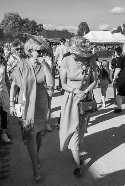 Two chic women take a walk along the horse racing track in Wrocław.