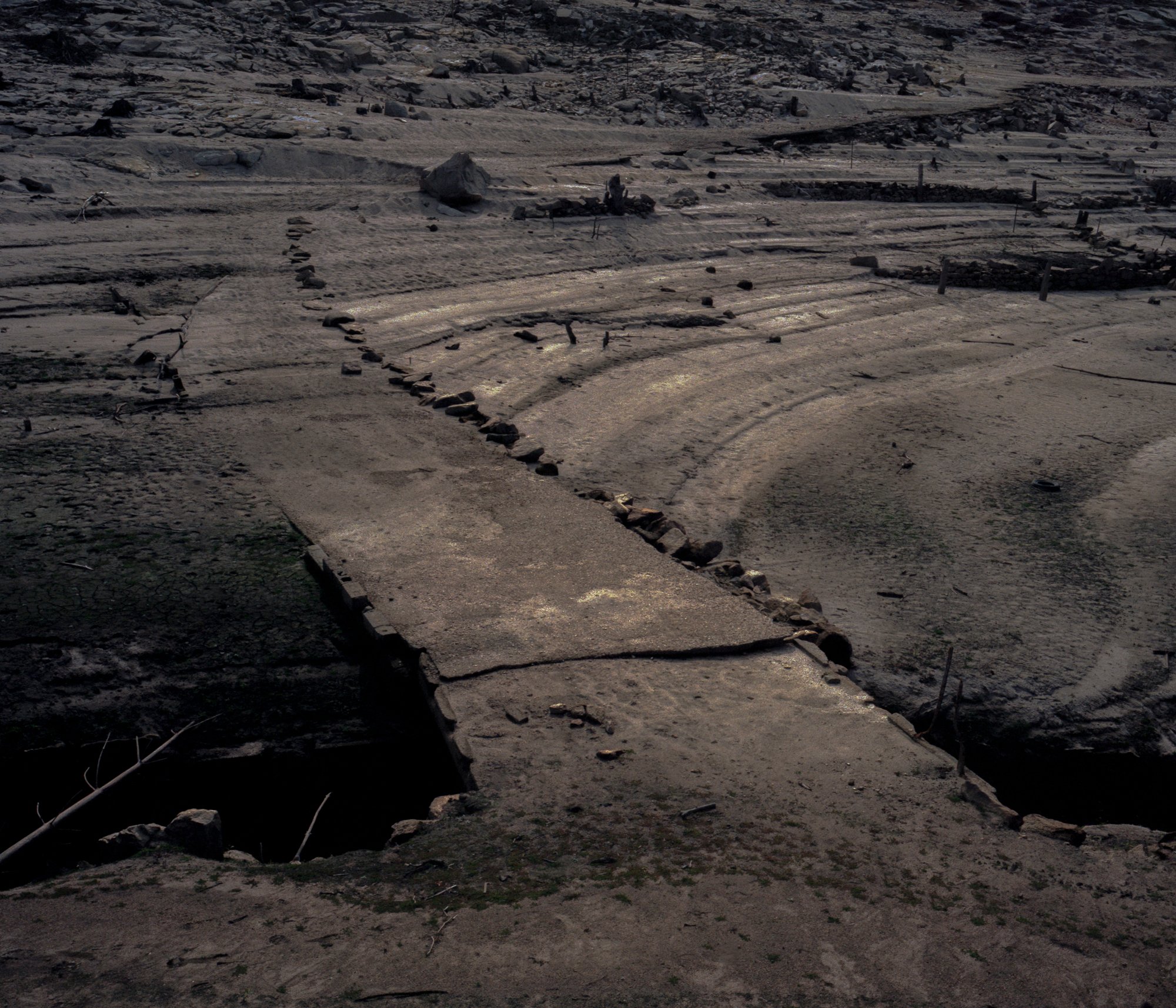 Bridge to hell. The remains of an almost wrecked bridge remind the Christian idea of the “Bridge to Hell.” In the Christian tradition, it is known as the “Bridge to Hell,” a metaphorical bridge that separates the world of the living from the world of the dead. All souls must cross the bridge after death. It is not a real physical construction, but a rhetorical figure that evokes the idea of a path or a decision that leads to negative or disastrous consequences. It is an expression used to illustrate the seriousness of a situation or the harmful potential of certain actions. Galicia, known for its deeply rooted beliefs and rich folklore, has long been a land steeped in mysticism. Legends of witches, spirits, and sacred rituals have shaped its cultural identity, blending pagan traditions with Christian spirituality. This intersection of the mystical and the religious is palpable in Galicia's population on both spiritual symbolism and the weight of Galicia’s ancestral narratives. © Carlos Folgoso Sueiro