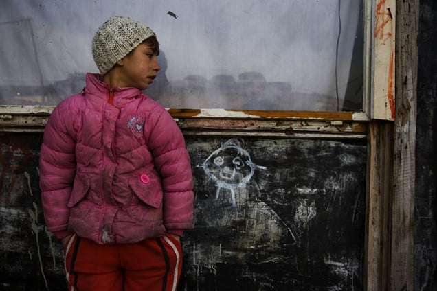 A Roma outside of a makeshift home in the Belville camp in New Belgrade. © Matt Lutton