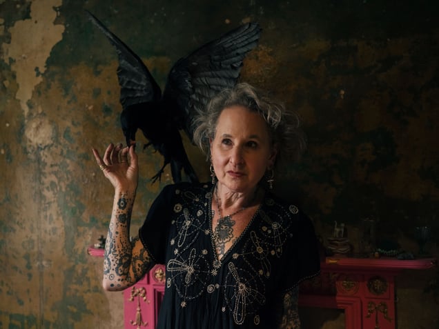Carey feeding a chicken heart to a crow