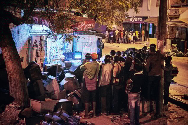 A group of people watch the wrestling match on television in Dakar, Senegal, 04 April 2015.