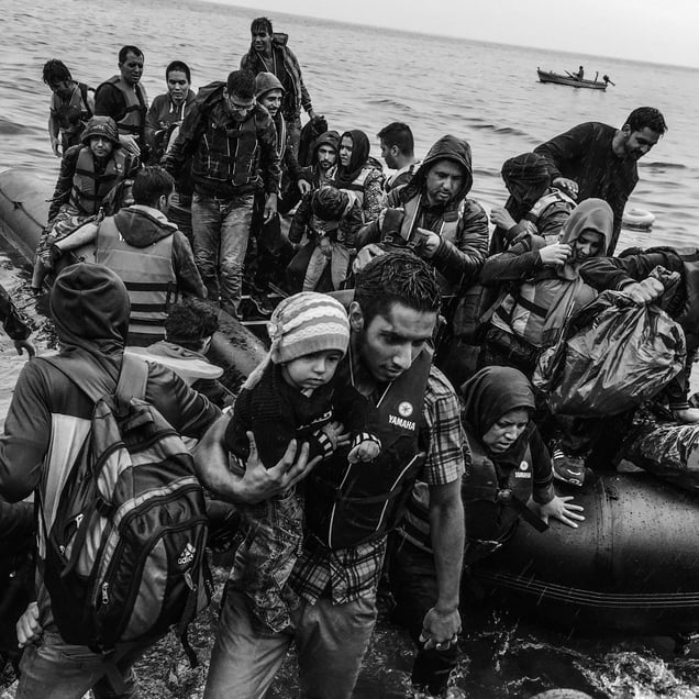 A boat packed with refugees lands on the coast of Lesbos, Greece.