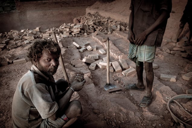 Squatting Brick Worker