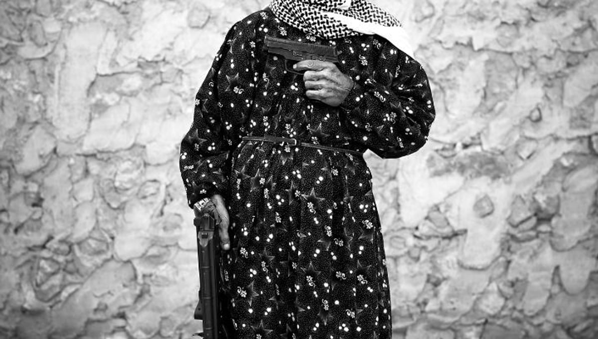 Om Ahmad, 72 years old, housewife with 3 children: "My house in Dar’a was destroyed by 2 bombs…I moved to Aleppo with my family, I chose to pick up a weapon and fight the regime.” © Sebastiano Tomada