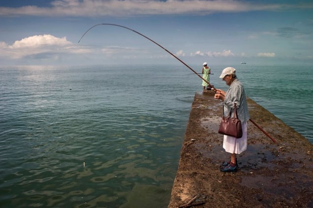Georgia, Ochamchira, AbkhaziaNina (front) and her daughter fish from a concrete jetty. They need the fish to supplement their meagre diet. Nina get EUR 50 from her state pension. She used to work in a local fish canning factory but it was destroyed in the separatist war of 1992 - 1993 when Abkhazia effectively seceded from Georgia.© Petrut Calinescu