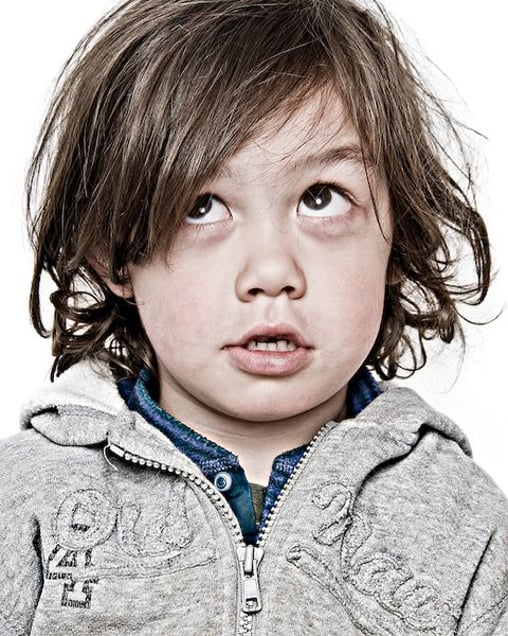 Ashton R., reluctant to have his photo taken without his dad in it with him. From the Series "Everyone My Brother Knows in Girdwood, Alaska" © Laura Domela