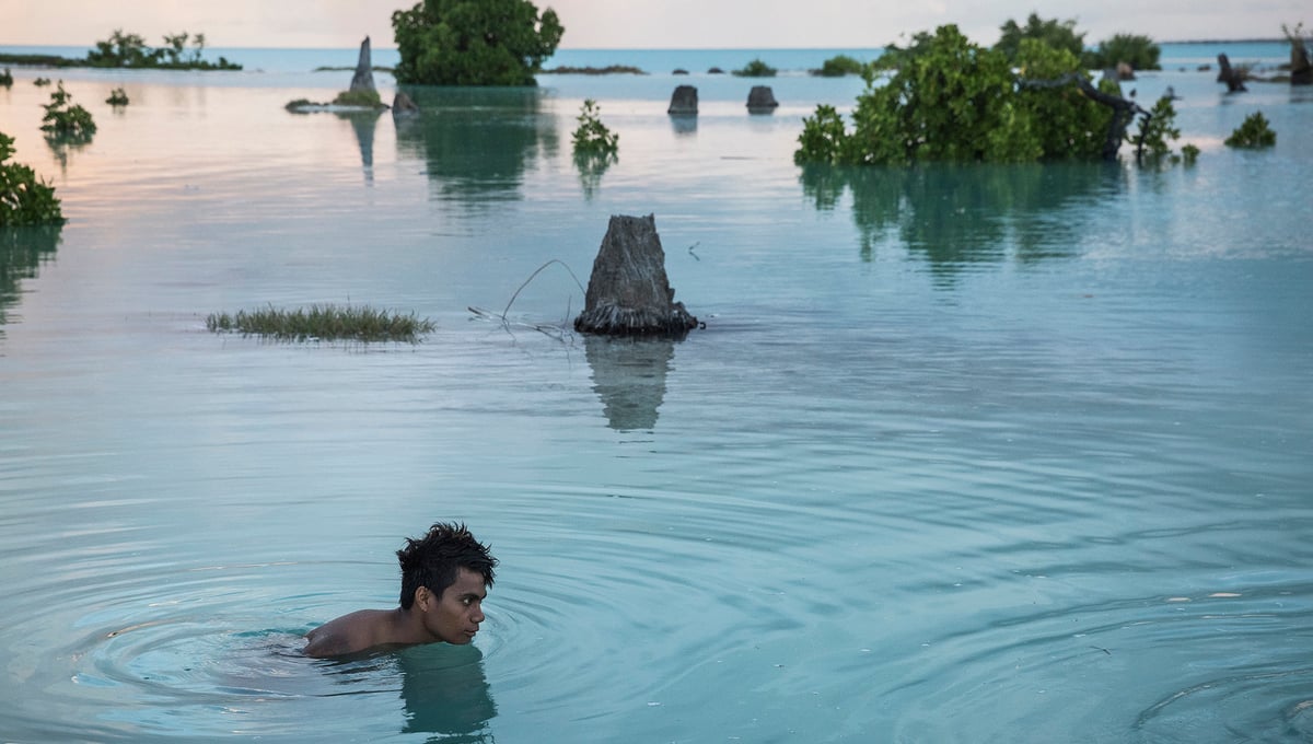 Peia Kararaua, 16, swims in the flooded area of Aberao village that is located in Tarawa atoll, Kiribati. Kiribati is one of the countries most affected by sea level rise. During high tide many villages become inundated making large parts of them uninhabitable.