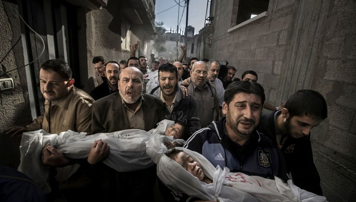 World Press Photo of the Year 2012 © Paul Hansen, Sweden, Dagens Nyheter.  20 November 2012, Gaza City, Palestinian Territories. Two-year-old Suhaib Hijazi and her three-year-old brother Muhammad were killed when their house was destroyed by an Israeli missile strike. Their father, Fouad, was also killed and their mother was put in intensive care. Fouad's brothers carry his children to the mosque.