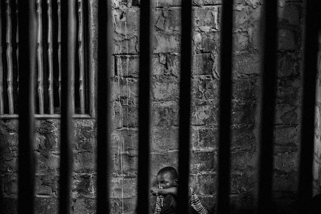 Abdoulaye, 15, is a talibe imprisoned in a room with security bars to keep him from running away. Thies, Senegal, 18 May 2015.