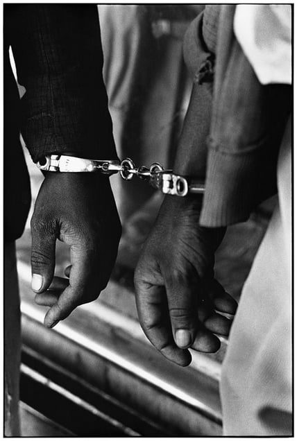 Handcuffed blacks, arrested solely for being in a white area illegally.