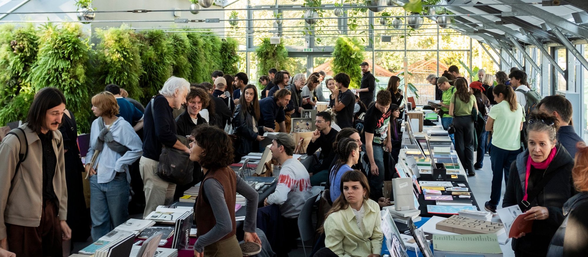 At Photobook Mania in Bologna, Italy. Photobook fairs often offer great opportunities to meet the artists and authors directly during book signings and public talks. Many authors hang out at a publisher’s stand to talk with people who are browsing the books. © Photobook Mania