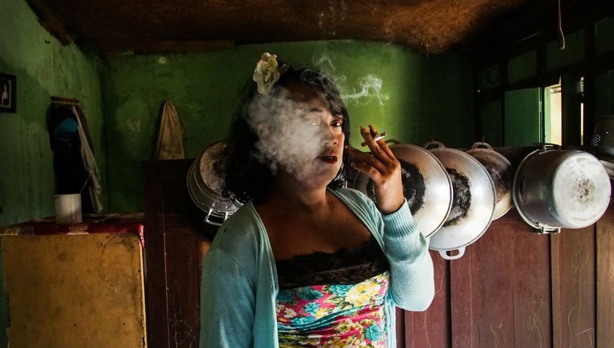 Nur smoking a cigarette in her kitchen