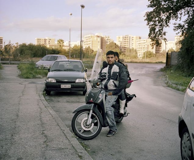 Scampia, Naples.
"The killer of Scampia," 31 years old, with his girlfriend at the Vela Rossa, the most notorious of three buildings in the Scampia neighborhood of Naples. He served 12 years in prison for a murder he committed when he was 19. He has two trials going at the moment for robbery and some misdemeanor crimes for which he might serve another 20 months. He and his girlfriend were arguing when I met them. He agreed to me taking the portrait, she didn't.
© Valerio Spada.
