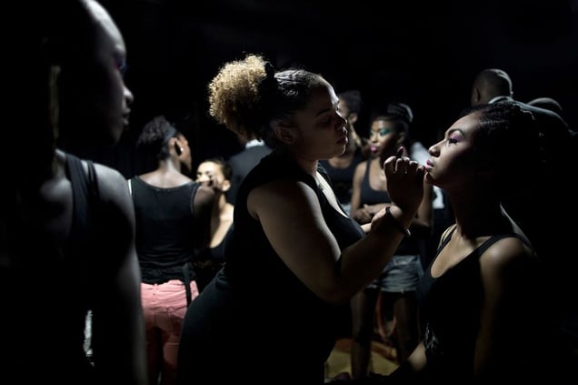 In the basement of the youth center, girls are makeup before a fashion show. © Hugo Aymar