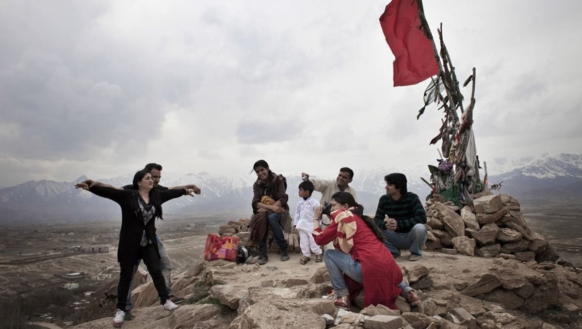 Miming Titanic on the top of Cargha lake, a recreational area | Kabul, Afghanistan 2013 © Sandra Calligaro