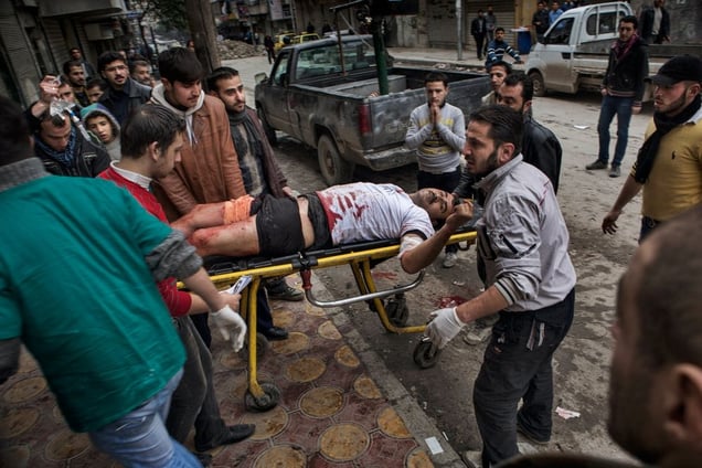 A man wounded by Syrian government shelling is wheeled into a field hospital on a stretcher in the Shaar district of Aleppo on February 7, 2013. © Nish Nalbandian