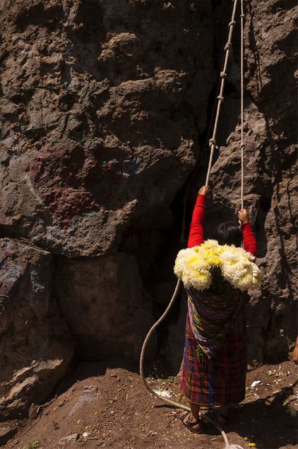 A local carrying flowers climbing the Almolonga volcano, also called Cerro Quemado, in Guatemala. The ancient Maya believed that volcanoes were holy places where the Gods and spirits resided. Cerro Quemado is considered one of the best places to get close to the Gods. Thats why people come from all over the region to pray and perform ceremonies, bringing flowers and sometimes food and alcohol to leave as offerings to God and the ancestors. Some people also believe that Juan Noj, a supernatural Maya being lives in the volcano.