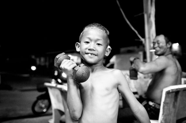 A boy, 7 years, wants to become a famous boxer. His father in the background is his trainer. © Sandra Hoyn